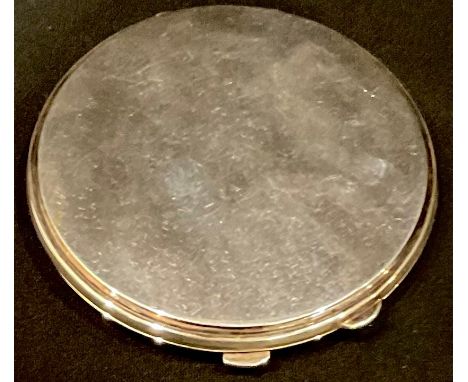 An Elizabeth II silver circular powder compact of plain design, hinged covers, interior mirror, original fabric mesh, 8cm dia