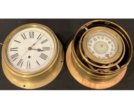 A brass ship's compass on a gimble, 20.5cm diameter; a brass porthole clock, white dial, Roman numerals, single winding hole,