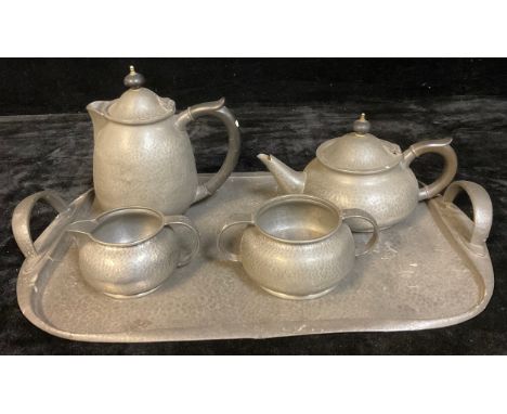 A Tudric planished pewter two handled tray, lily pad terminals, number 043, 48cm wide; a Tudric coffee pot, milk jug and suga