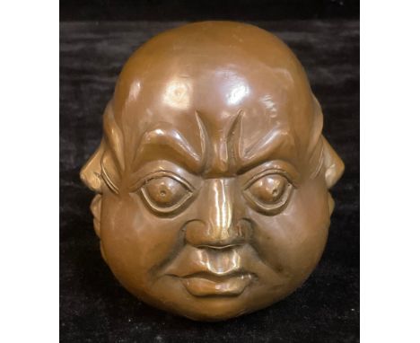 A bronze coloured metal desk weight, as four faces, 15cm high 