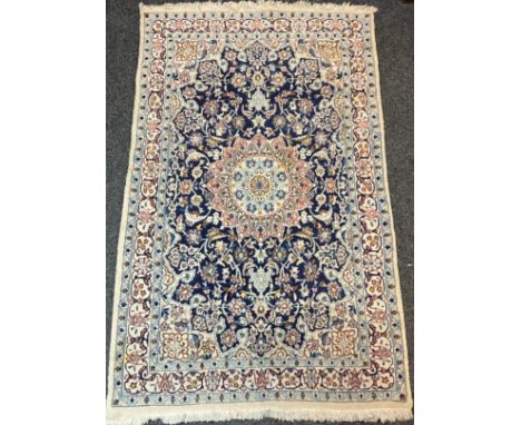 A Middle-Eastern rug or carpet, in tones of cream, blue and red, 191cm x 117cm 