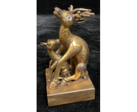 A Chinese gilt metal two piece seal as a stag with fawn, 13cm high, 20th century 