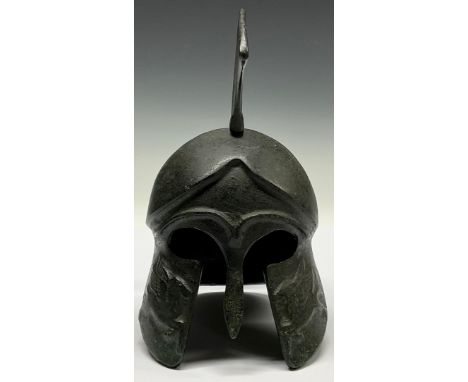 A museum type patinated bronze model, of an Ancient Greek helmet, 19cm high 