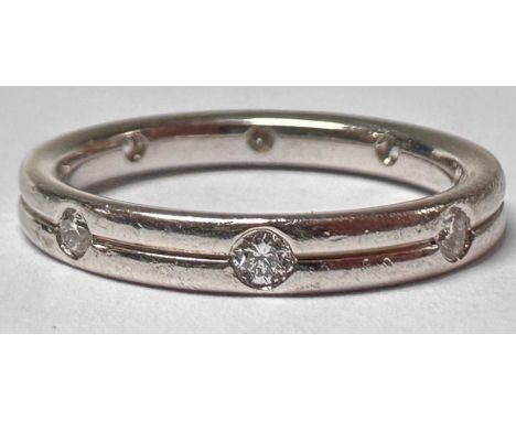 An 18ct white gold eternity ring, set with eight brilliant cut diamonds, size M, marked 750, 3.8g 