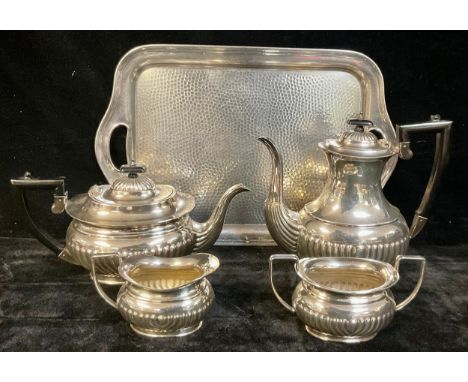 A silver plated four piece boat shaped tea service, on a planished pewter two handled tray (5) 