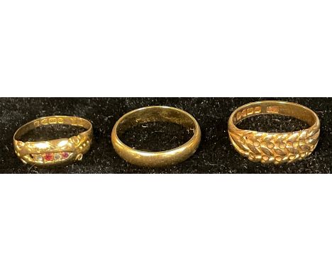 An 18ct gold wedding band, size O, marked 750, 3.9g; two 18ct gold rings, 6.5g (3) 