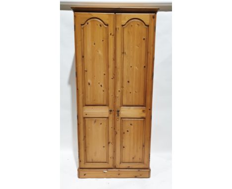 20th century pine two-door wardrobe&nbsp;opening to reveal an adjustable shelf and clothes rail, one door mirrored on the ins