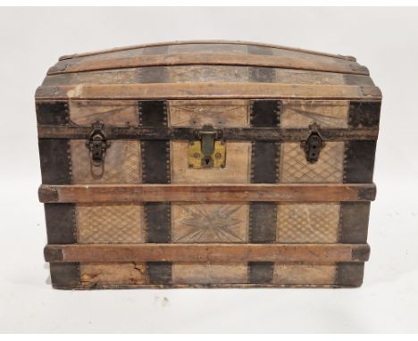 Late 19th/early 20th century tooled leather, oak and iron-banded travelling trunk, of domed form, tooled with starbursts and 