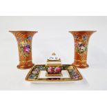 Pair of French porcelain trumpet-shaped vases painted with bouquets of flowers on a gilt scale-