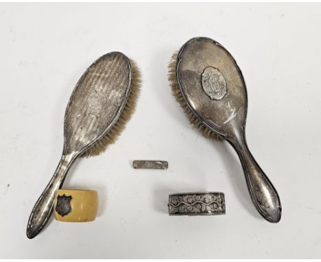 Two silver-mounted dressing table brushes, one&nbsp;with monogrammed initials,&nbsp;a white metal hinged bangle and&nbsp;a si