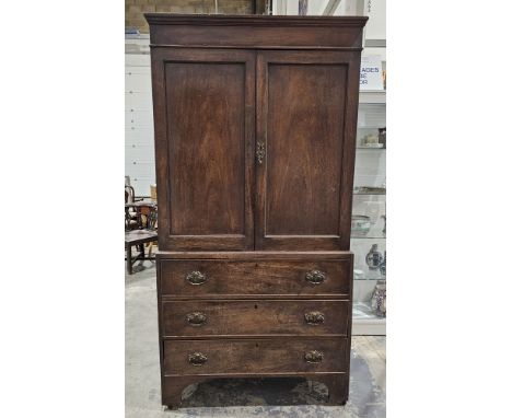 Victorian mahogany linen press&nbsp;with two door cupboards opening to reveal various shelves, raised over three long drawers