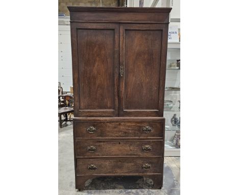 Victorian mahogany linen press&nbsp;with two door cupboards opening to reveal various shelves, raised over three long drawers