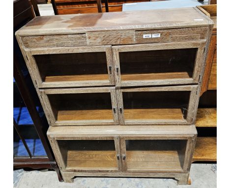 Limed oak stacking bookcase, three-section, each with two glazed doors, on bracket feet, 120cm high x 89cm wide x 27cm deep&n