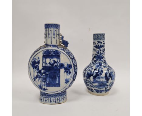 Two Chinese porcelain blue and white Qing Dynasty vases, the first of moonflask form with pierced beast terminals, painted wi