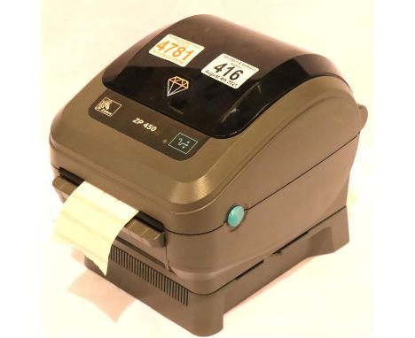 Zebra ZP-450 thermal label printer with a quantity of jewellery dumbbell labels, working at lotting, spool with home-made rep