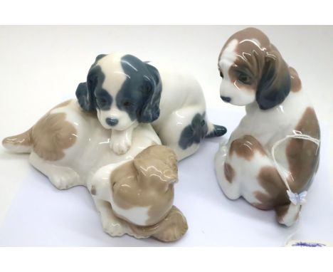 Nao and Lladro ceramic figurines to include Gentle Surprise and two puppies playing. P&amp;P Group 2 (£18+VAT for the first l