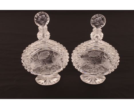 A pair of heavy crystal decanters with profuse hobnail pattern and fruit and foliage decoration;  a 19th Century triple ring 