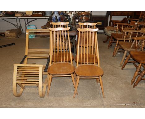 A set of four blond Ercol stick back dining chairs 