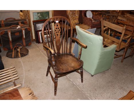 An elm seated stick and wheel back elbow chair 