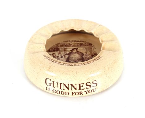 An unusual 1920's pressed glass Bonzo inkwell and a Willshaw and Robinson Guinness advertising ash tray