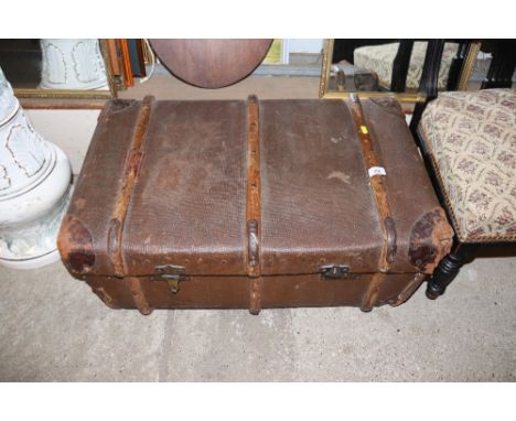 A circa 1950's battened leather and canvas school trunk