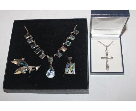 A brooch in the form of dolphins decorated with abalone shell; a single abalone shell ear-ring; a similar crucifix hung to fi