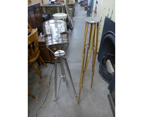 A chrome tripod spotlight and a wood tripod