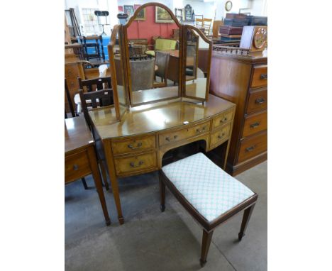 An Edward VII walnut bow front dressing table, mirror and stool