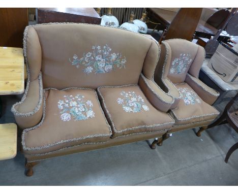 A 1920's walnut and upholstered Queen Anne style sofa and armchair