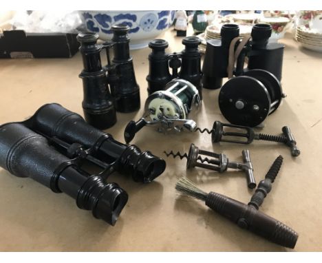 A pair of military binoculars, three vintage corkscrews, fishing reels Etc