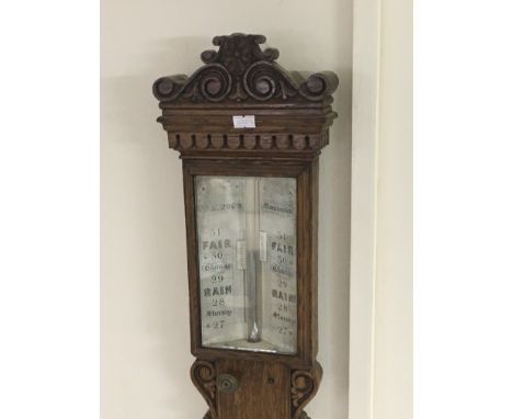 A quality oak late 19th Century stick barometer maker J W Wood of Manchester with a silvered dial