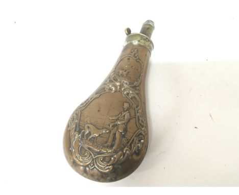 A 19th century brass powder flask decorated with a hunting scene.