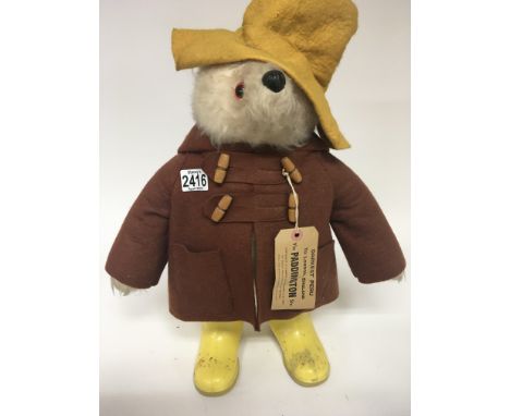 A Vintage Paddington Bear with yellow boots and hat and tag in-tacked.