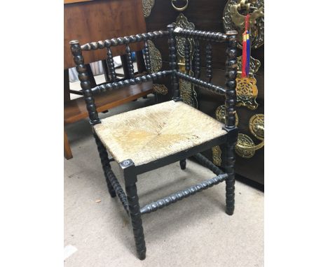 A bobbin turned corner chair with a rush seat.