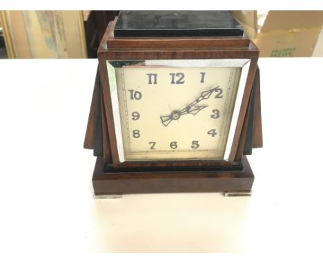 An Art Deco style mantle clock. 19cm wide by 18cm tall. Seen working.Postage C.