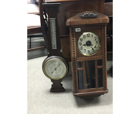 An oak wall clock with a visible pendulum and an oak barometer (2)