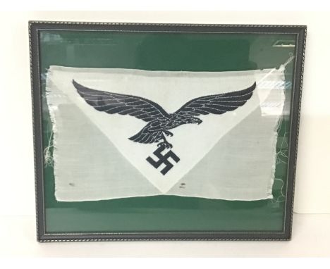 WW2 German Luftwaffe Sports Vest BeVo Patch. Black embroidered Eagle in flight clutching a Swastika on a white ground. Framed