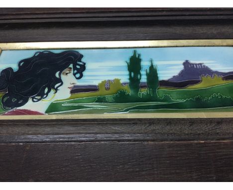 A pair of oak framed Art Nouveau style tube lined tiles depicting maiden and landscapes 36 cm by 12 cm