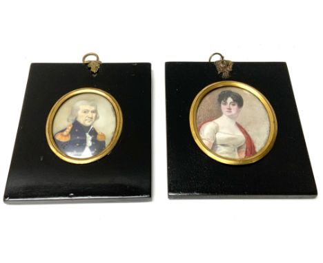 2 early hand painted oval miniature portrait paintings of a Lady and and Officer with ebonized frames. 10cm x 12cm.