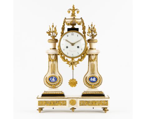 A Portico Mantel Clock, Ridel à Paris, Marble mounted with Bronze and Porcelain Plaques in Wedgwood style, Louis XVI.Portico 