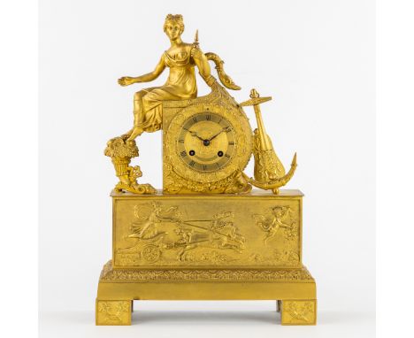 A Ormolu Mantel Clock, Allegory of Hope, Empire, 19th century.Ormolu table clock.Brass.Mounted with a lady with anchor and ho