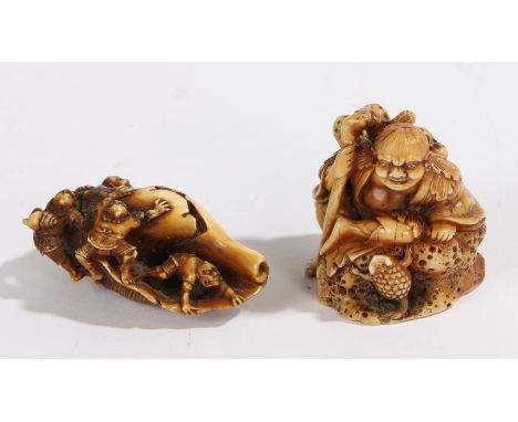 Two Japanese ivory netsuke, Meiji period, the first with a shell and figures crawling about it, the second of a figure restin