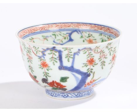 Chinese porcelain bowl, Kangxi, the inner rim decorated in red swirls above branches and gilt flowers, the centre of the bowl