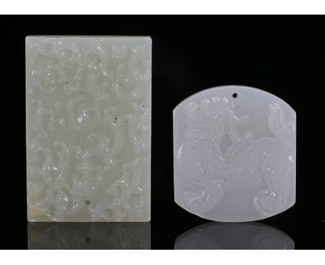Two 19th Century Chinese jade pendants, an example carved with a temple guardian lion the other a stylised dragon amongst clo