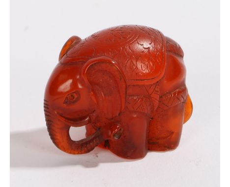 Japanese netsuke, the amber effect elephant signed to the base, 30mm high