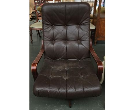 A vintage leather button back armchair on stained bentwood frame and swivel base 