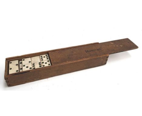 A set of vintage wooden dominoes in case 