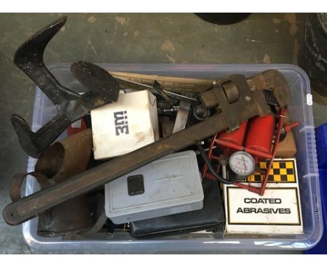 A clear plastic box of tools including a very large adjustable spanner 
