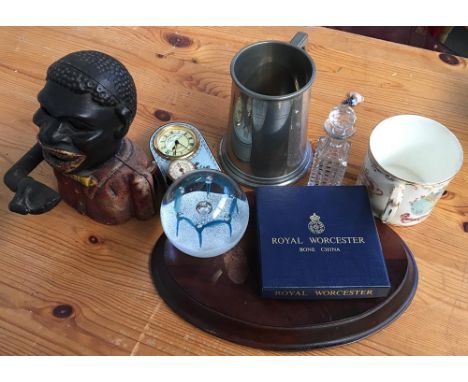 A metal piggy bank, embossed 'Jolly Nigger Bank' to reverse, together with a Caithness glass paperwight, Royal Worcester pin 