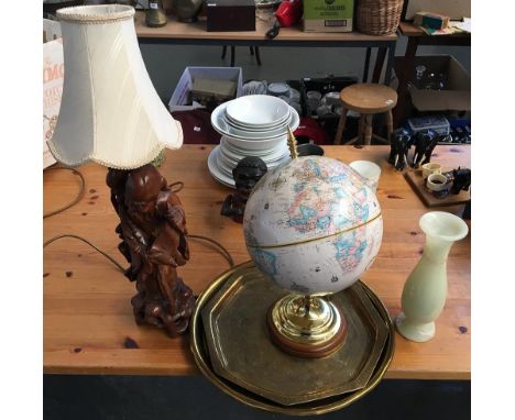 Two brass trays, one engraved with Islamic patterns, together with a globe, carved Oriental lamp, and onyx vase 